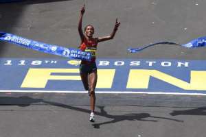Rita Jeptoo of Kenya crosses the finish line to win the Women's Elite division of the 118th Boston Marathon on April 21, 2014.  By Timothy A. Clary AFPFile