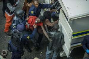 South African officers arrest illegal immigrants and foreign nationals during a raid in the Johannesburg CB on May 8, 2015.  By Mujahid Safodien AFPFile