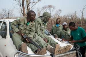 Researcher Martial Kiki right fills in data sheets with rangers during a lion population estimate at Nigeria's Yankari Game Reserve.  By Stefan Heunis AFPFile