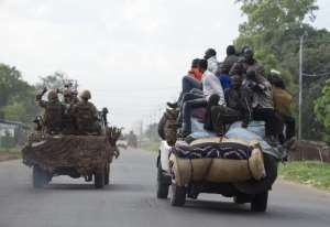 Members of the Seleka former rebels R drive near a convoy of Chadian soldiers leaving Bangui escorted by the African-led International Support Mission to the Central African Republic MISCA on April 4, 2014.  By Miguel Medina AFPFile