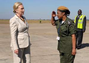 US Secretary of State Hillary Rodham Clinton is saluted by Mary Tembo, then commanding officer of the Zambian National Police at Lusaka International Airport in Lusaka, Zambia, on June 11, 2011.  By Susan Walsh PoolAFPFile