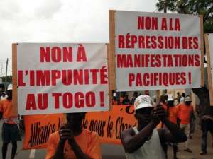 Opposition supporters rally with banners reading No to impunity in Togo, No to repression of peaceful demonstrations.  By Emile Kouton (AFP/File)