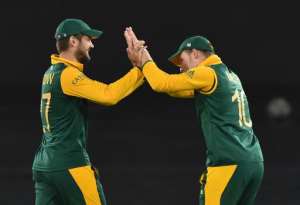 South Africa's Rilee Rossouw left celebrates taking a catch with David Miller during a World Cup match against Ireland in Canberra on March 3, 2015.  By Peter Parks AFP