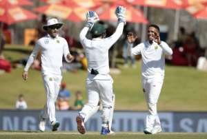 South African bowler Dane Piedt R celebrates the dismissal of New Zealand batsman BJ Watling unseen on the fourth day of the second Test match in Centurion, South Africa on August 30, 2016.  By Gianluigi Guercia AFP