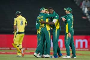 South African team members congratulate Kagiso Rabada C after hebowled Australia's Mitchell Marsh L out during the One Day International Cricket match on October 12, 2016, in Cape Town.  By Rodger Bosch AFP