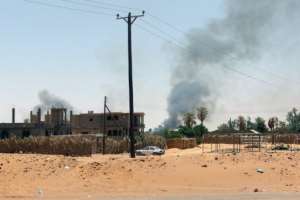 Black smoke billows as fighting takes place in the southern oasis city of Kufra.  By  (AFP/File)