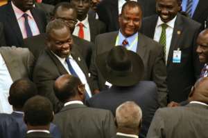 Rebel chief Riek Machar L and South Sudan's President C attend peace deal talks in Addis Ababa on August 17, 2015.  By  AFP