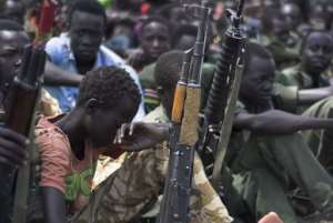 Young boys, children soldiers sit on February 10, 2015 with their rifles at a ceremony of the child soldiers disarmament, demobilisation and reintegration in Pibor oversawn by UNICEF and partners on February 10, 2015.  By Charles Lomodong AFPFile