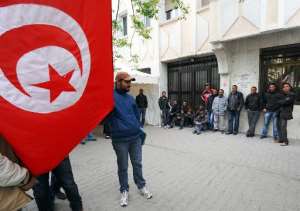 File photo for illustration shows unemployed men blocking the access to the Labour Ministry headquarters in Tunis on April 20, 2012.  By Fethi Belaid AFPFile
