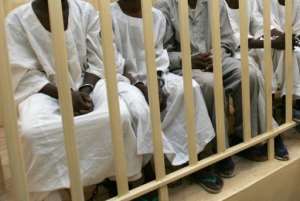 Accused men sit behind bars during a hearing in a court room in Omdurman, Sudan, on August 20, 2008.  By Ashraf Shazly (AFP/File)