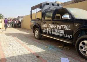 A crime patrol is seen outside the partially burnt police station in the Sheka neighbourhood of the northern Nigerian city of Kano on January 25, 2012.  By Aminu Abubakar AFPFile