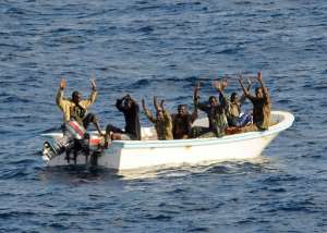 Suspected pirates keep their hands in the air as directed by a patrol from the guided-missile cruiser USS Vella Gulf, in the Gulf of Aden.  By Jason R. Zalasky Navy Visual News Service NVNSAFPFile
