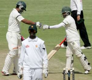 Bangladeshs Tamim Iqbal (L) and Mominul Haque congratulate one another as they play Zimbabwe in Harare, April 25, 2013.  By Jekesai Njikizana (AFP)