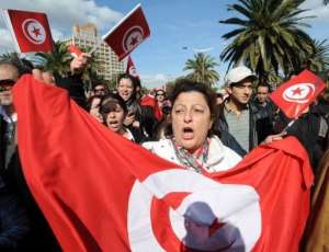 Tunisian people demonstrate on Habib Bourguiba Avenue in Tunis.  By Fethi Belaid AFP
