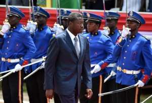 Togo's President Faure Gnassingbe walks past an honour guard in Lome on April 27, 2015.  By Issouf Sanogo AFPFile