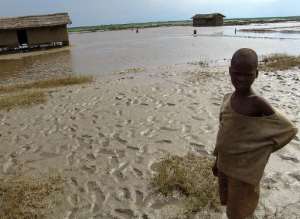 A displaced Burundian boy stands outside houses destroyed by floods at Gatumba, near Bujumbura on January 25, 2007.  By Wfp World Food ProgrammeAFPFile