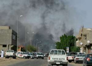Smoke rises from a road in the district of Gardah in the southern Libyan town of Sabha.  By - AFP