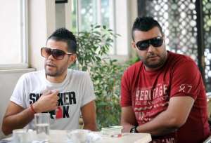 Tunisian rappers Mustapha Fakhfakh L and Aymen El-Fikih R wait for their trial at a court in the Tunis suburb of Ben Arous on October 7, 2013.  By Fethi Belaid AFP