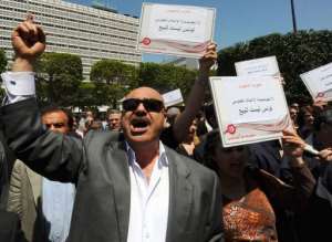 Tunisian journalists shout slogans during a sit-in outside the theatre municipal in Tunis.  By Fethi Belaid AFP