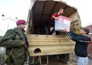 Employees from the Independent High Authority for elections ISIE offload ballot boxes from a military vehicle under the surveillance of the Tunisian army, on December 20, 2014.  By Fethi Belaid AFPFile
