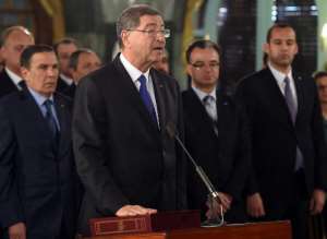 Newly-appointed Tunisian Prime minister Habib Essid takes an oath of office at a swearing-in ceremony for the new government at Carthage Palace in Tunis on February 6, 2015.  By Fethi Belaid (AFP)