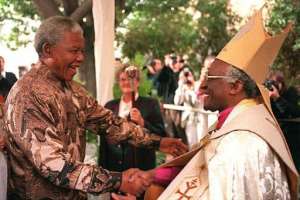 Desmond Tutu (right) greets Nelson Mandela at the entrance of St Georges Cathedral in Cape Town on June 23, 1996.  By  (AFP/File)
