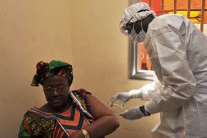 A woman gets vaccinated at a health center in Conakry during the first clinical trials of the VSV-EBOV vaccine against the Ebola virus on March 10, 2015.  By Cellou Binani AFPFile