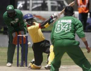 Uganda batsmen Joel Olweny misses a shot as Kenya bowler Hiren Varaiya right looks on during a Twenty 20 match at the Nairobi Gymkhana on  September 2, 2007.  By Simon Maina AFP