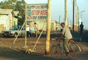 An Eritrean man is seen passing by an anti-Aids billboard in Assab city, on Febuary 17, 1999.  By Amr Nabil (AFP/File)