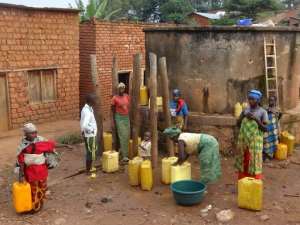 Burundian women fill water containers in Rwesero village on January 6, 2015.  By Esdras Ndikumana AFP