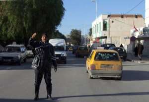 A Tunisian policeman directs the traffic in Kasserine in 2011.  By Jebberi AFPFile