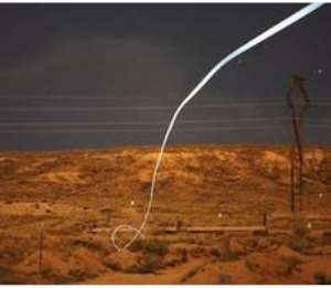 An LED attached to a prototype bullet shows its flightpath during a night-time field test.