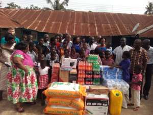 The NPP executives in a photograph with staff and immates of the orphanage. Infront are the donated items