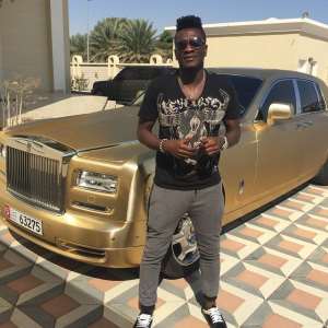 Asamoah Gyan with his gold-coloured Rolls Royce