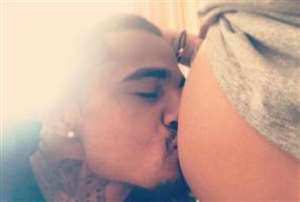 Kevin Prince Boateng kissing his girlfriend's belly last night as they await today's delivery
