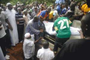 End of the road: The mortal remains of Alhaji Sly Tetteh being lowered into the grave at the Osu Cemetery in Accra.