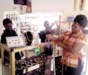 Mrs Yvette Kporjroh admiring some of her artifacts displayed in her showroom