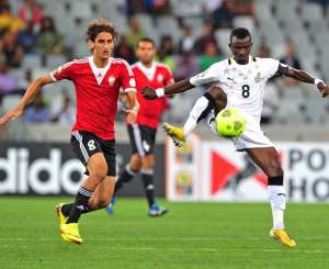 Jordan Opoku of Ghana gets to the ball ahead of Mohamed Elgadi of Libya during the 2014 CAF African Nations Championships Final between Libya and Ghana at Cape Town Stadium, Cape Town on 1 February 2014
