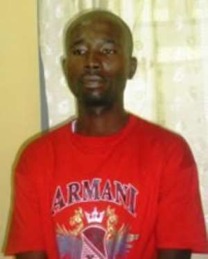 Charles Nkansah in handcuffs after his arrest