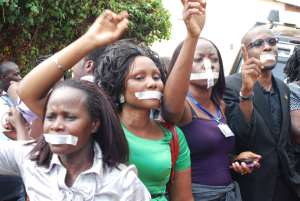 Human rights activists sealed their mouth with as a gesture to denounce the raid on media by Museveni’s security