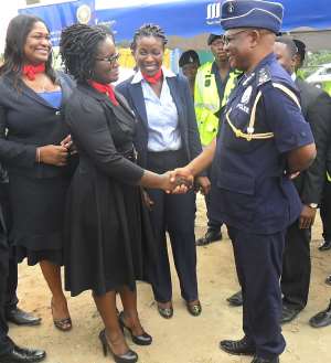 Director General COP John Kudor in a handshake with Sika Dove.