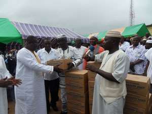 Regional Minister left receiving one of the Chocho productsfrom Alhaji Mustapha Oti Boateng