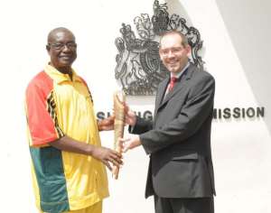 The Commonwealth Games Association President for Ghana Mr Benson Baba, presents the Queens Baton 2010 Delhi to the Deputy High Commissioner of Britain Mr Matthew Johnson on 15 December 2009.