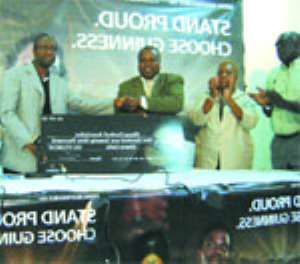 Mr. Okoli ( R) in a handshake with FAs Vice Prez., Mr. Fred Pappoe after  presenting  the  dummy cheque to the FA. With them is an official of GGBL