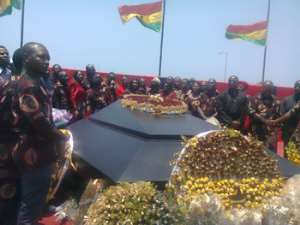 Members of the funeral planning committee surrounds the tomb of the late president