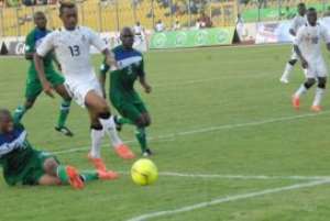 Two - goal hero Jordan Ayew takes on two Lesotho markers o