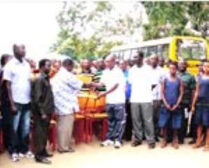 (above) Mr. Mohammed Abur-Sufian Master in-charge of Special Duties of the school, receiving the items from the DCE.