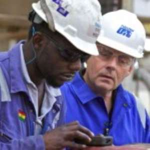 A Ghanaian oil worker and his foreign counterpart at work