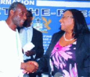 Alhaji Collins Dauda (left), Minister of Lands and Natural Resources, being congratulated by  Mrs Zita Okaikoi, Minister of Information
