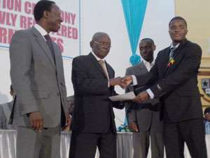 Kwaku Anane Sarpong receiving his certificate of recognition from Joseph Nyoagbe while James Ohemeng Kyei (left) looks on